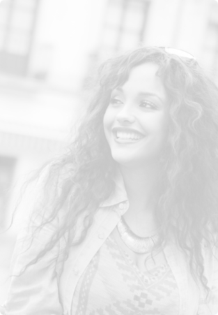 Young woman with curly hair smiling after receiving dental services in Topsham