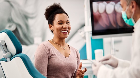 smiling patient during her implant consultation