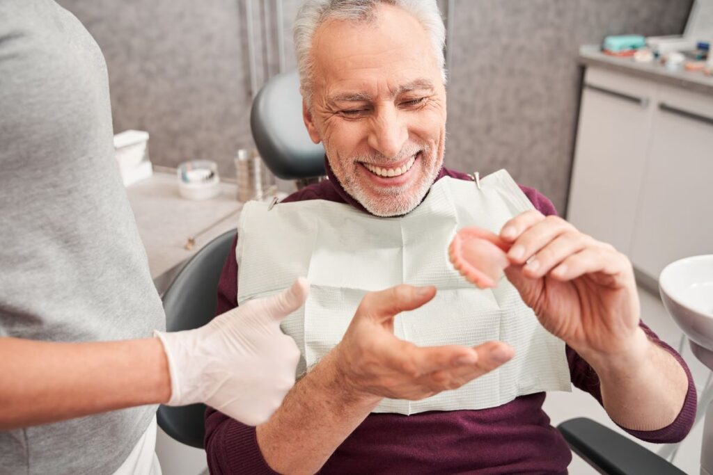 A man at the dentist for a denture checkup.